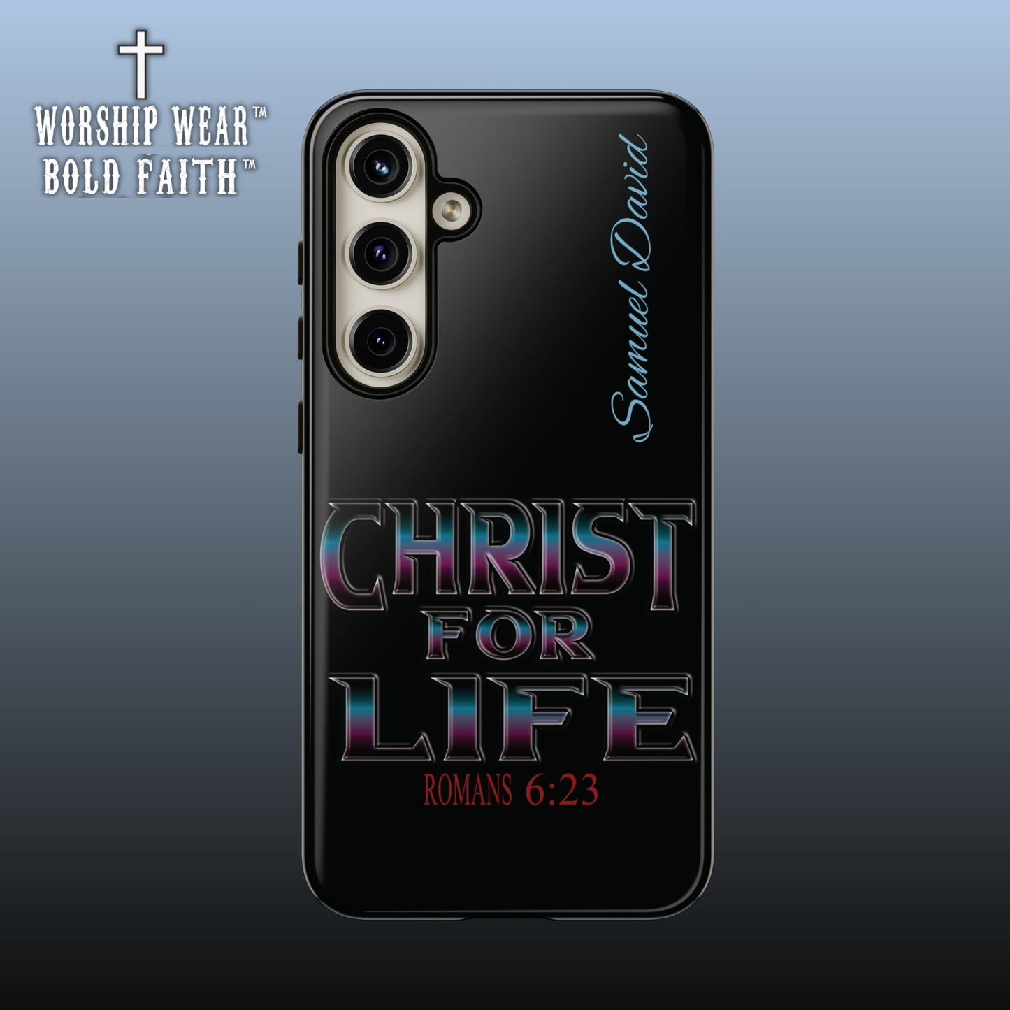 A black phone case featuring the text 'CHRIST FOR LIFE' in a metallic rainbow gradient font and 'ROMANS 6:23' in red at the bottom, with 'Samuel David' written in light blue script on the side. The case is shown on a smartphone against a dark blue gradient background, with the 'WORSHIP WEAR BOLD FAITH' logo in the top-left corner.